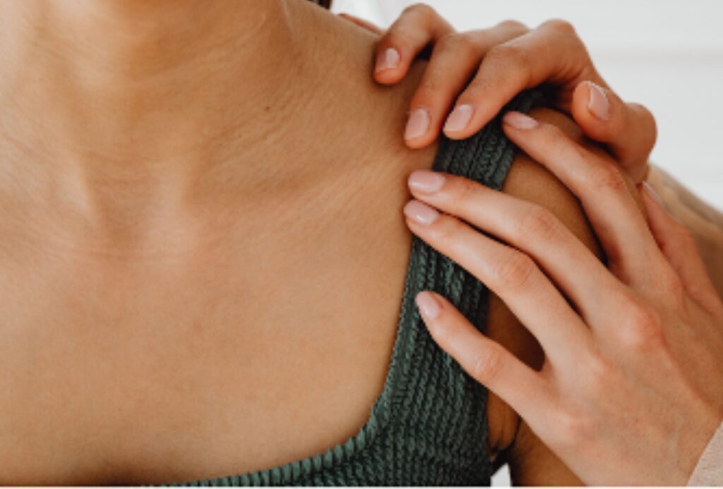 Therapist applying gentle bioelectric meridian therapy to a client’s shoulder for pain relief and recovery support